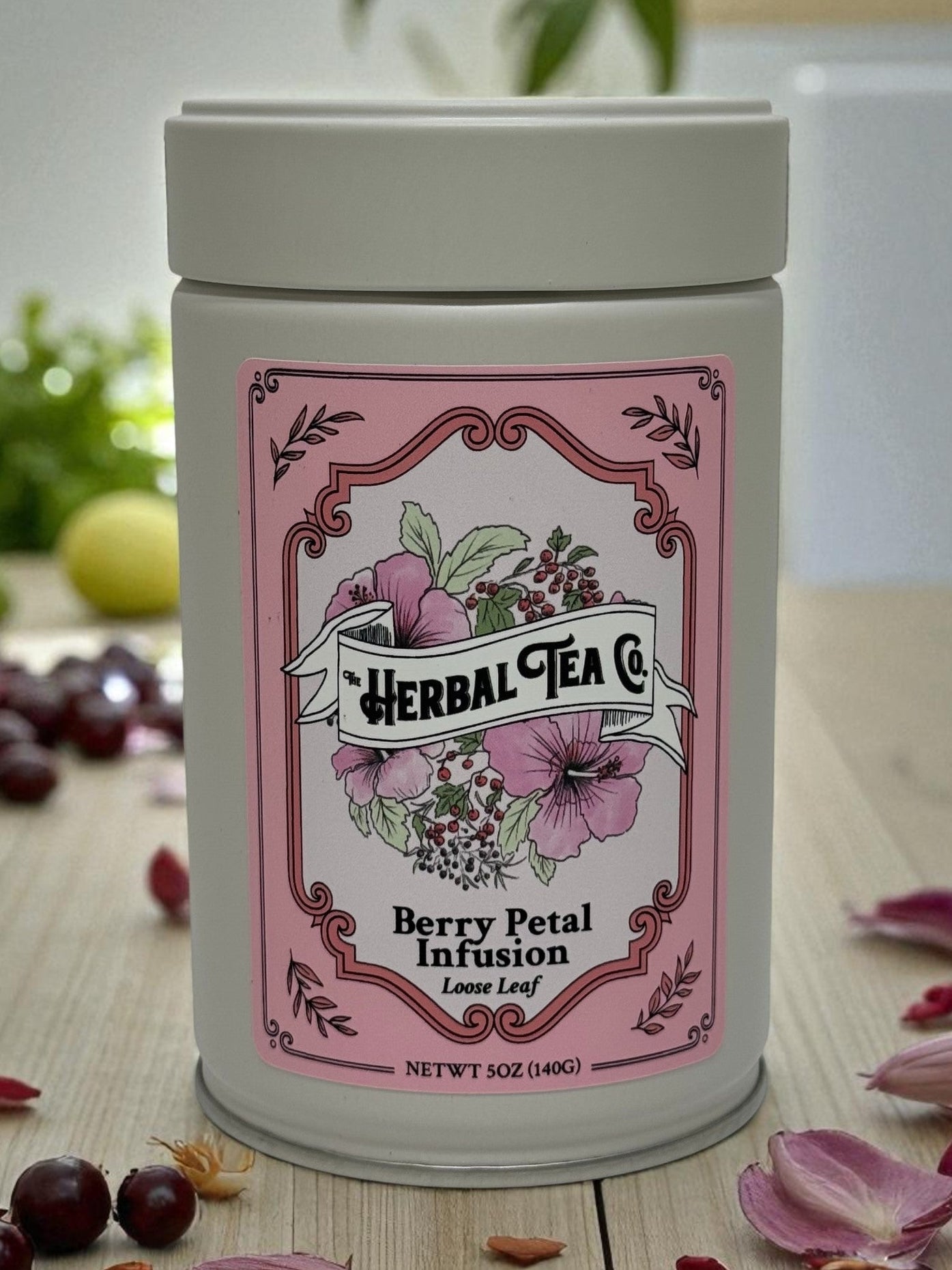 Berry Petal Infusion Herbal Tea tin with pink floral label featuring berries and hibiscus.