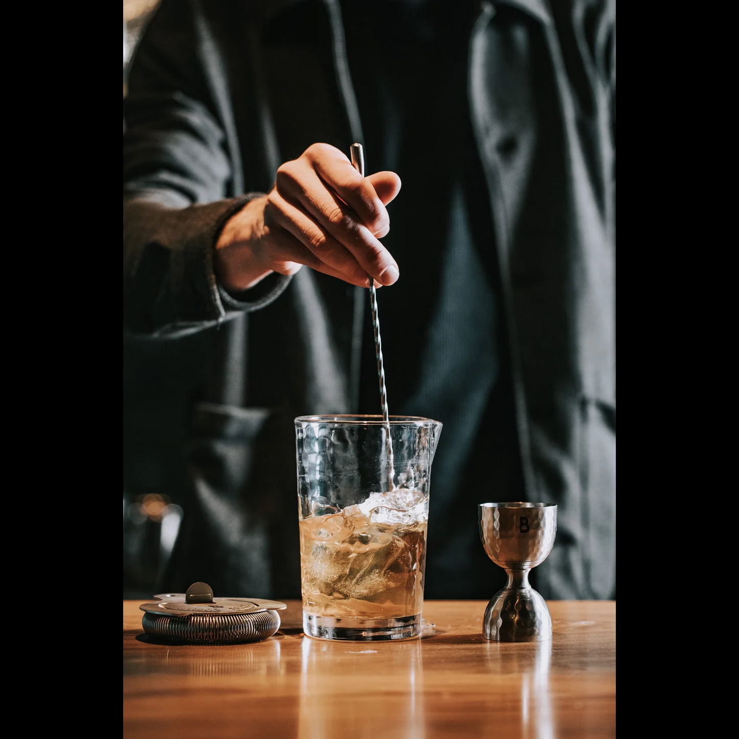 BULL IN CHINA The Flagship Mixing Glass with ice being stirred; durable, annealed, dishwasher-safe.