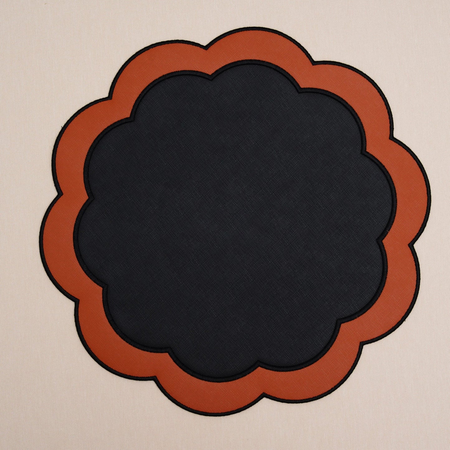 Serenity black-orange scalloped faux leather placemat, round 15.7-inch.