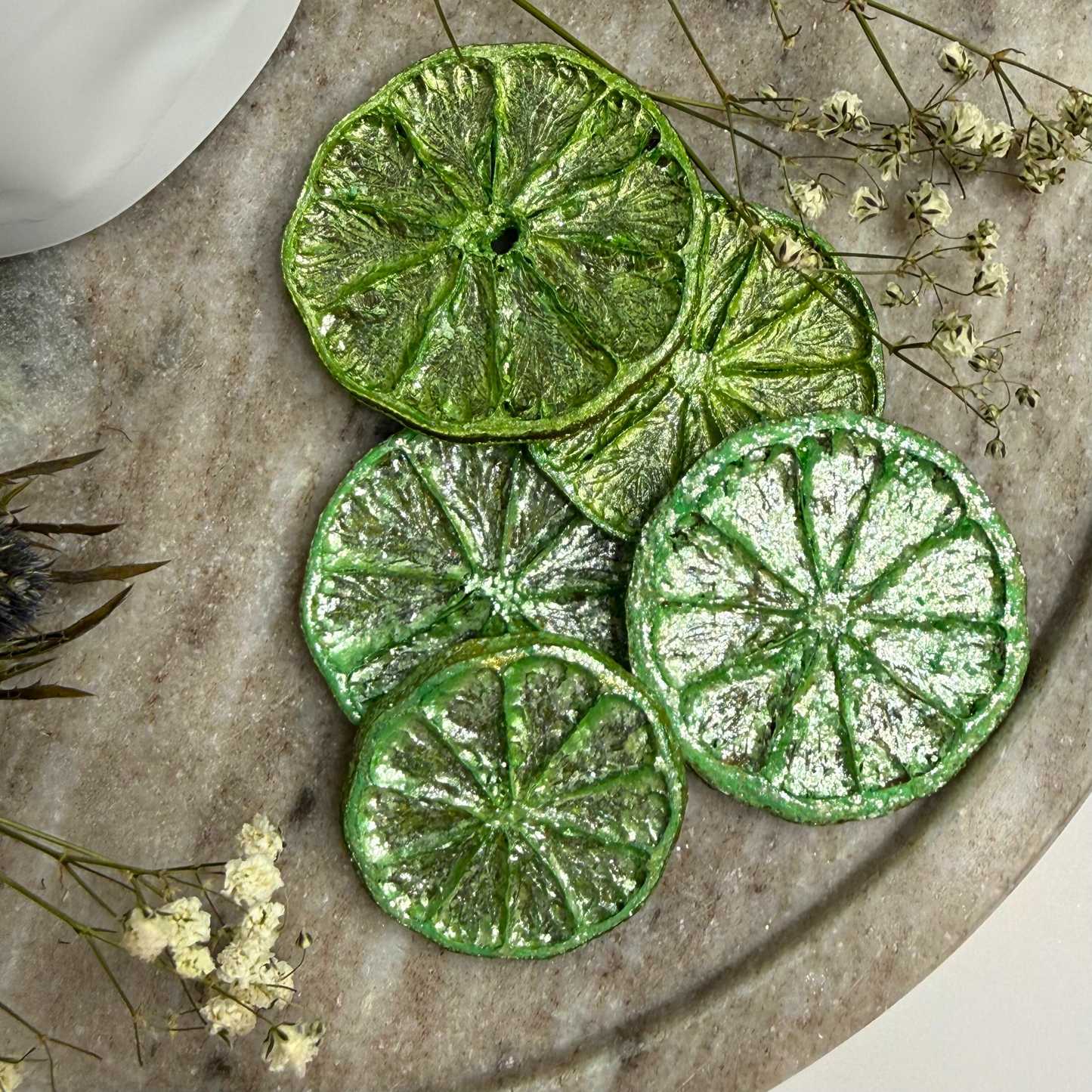 Wicked Inspired pink and green luster dust dried lime garnish set, 2-pack, glittery lime slices for drinks and decor.