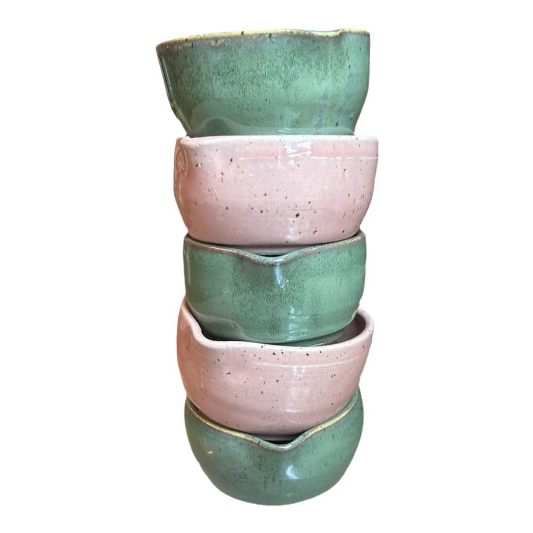 Stack of heart-shaped matcha bowls in pink and green glaze, handcrafted in NYC with Marina Caspe.
