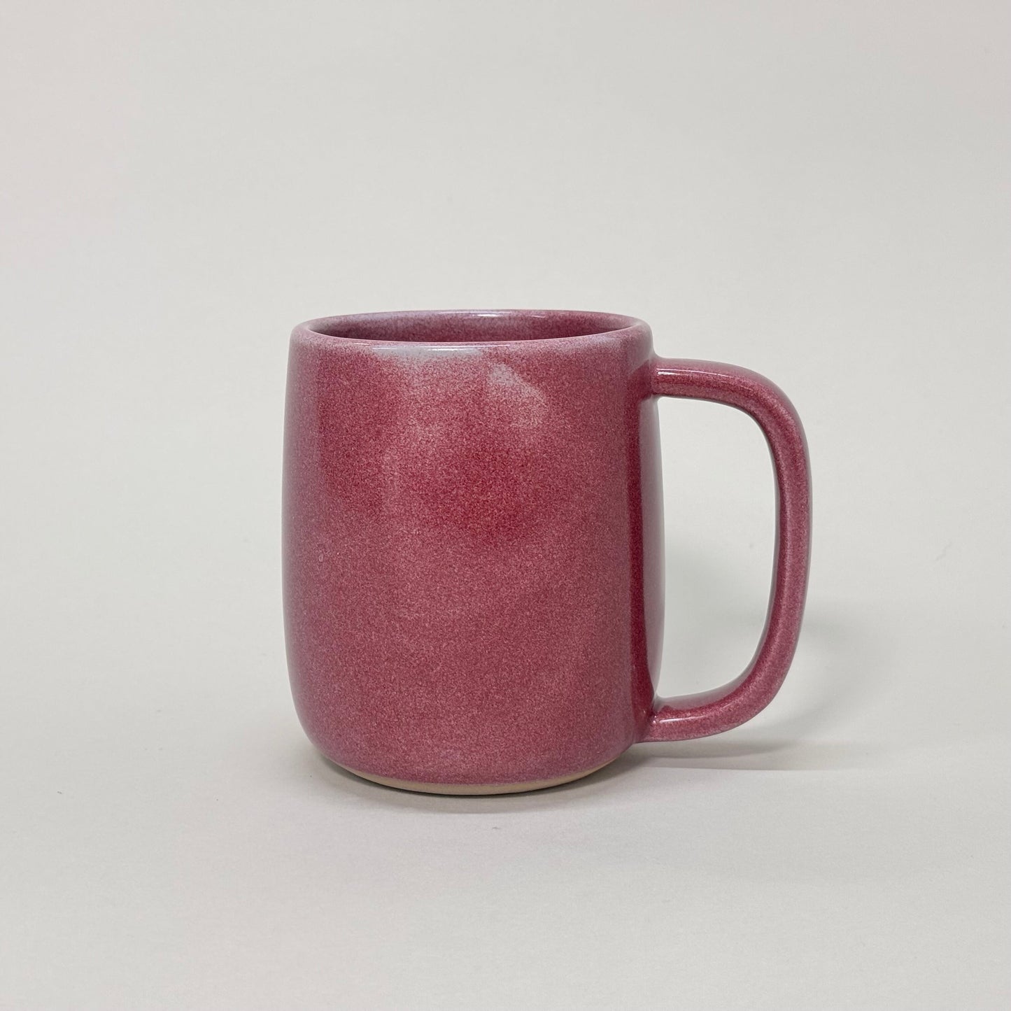The Standard Mug, a 12oz speckled red ceramic mug with a comfortable, ergonomic handle.