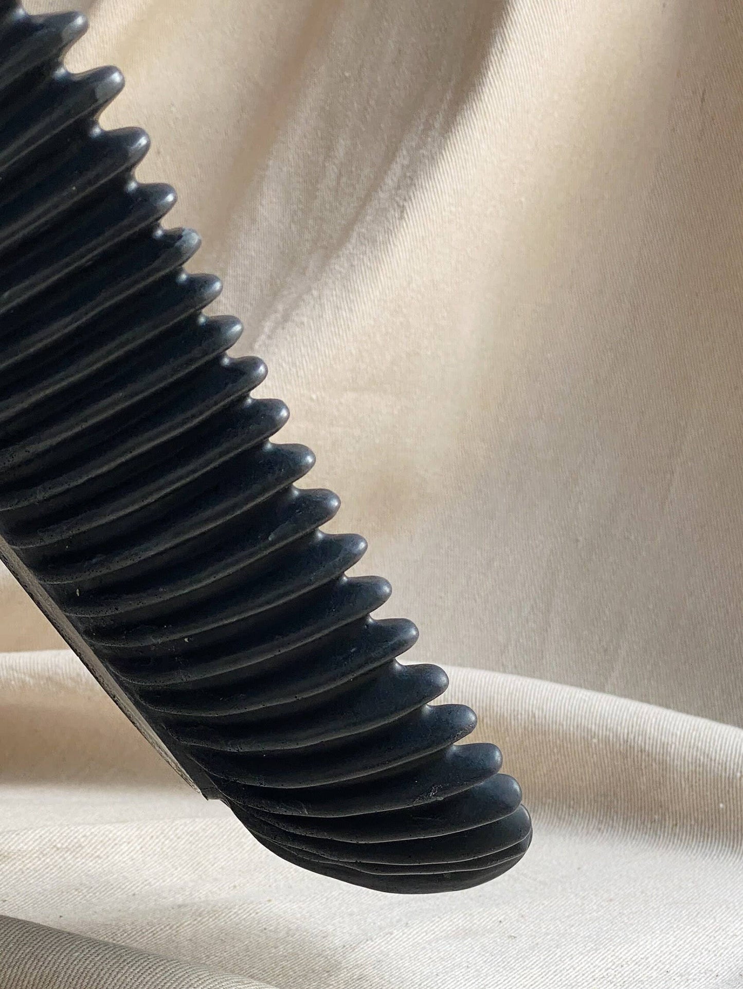 Black FORMA handmade concrete oval bowl with ribbed exterior, decorative centerpiece.