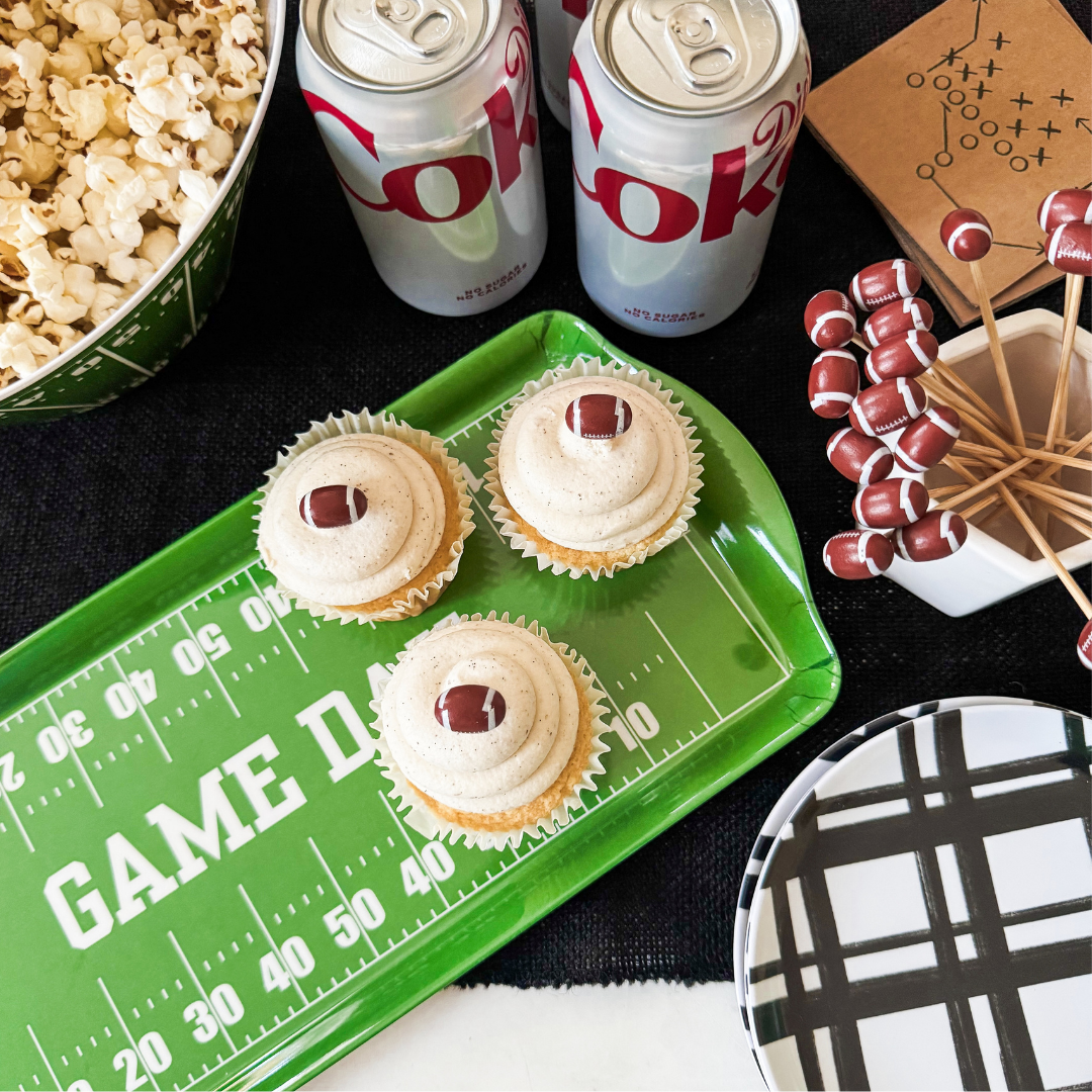 Green football field Melamine tray holding cupcakes at a tailgate party with popcorn and mini football picks.