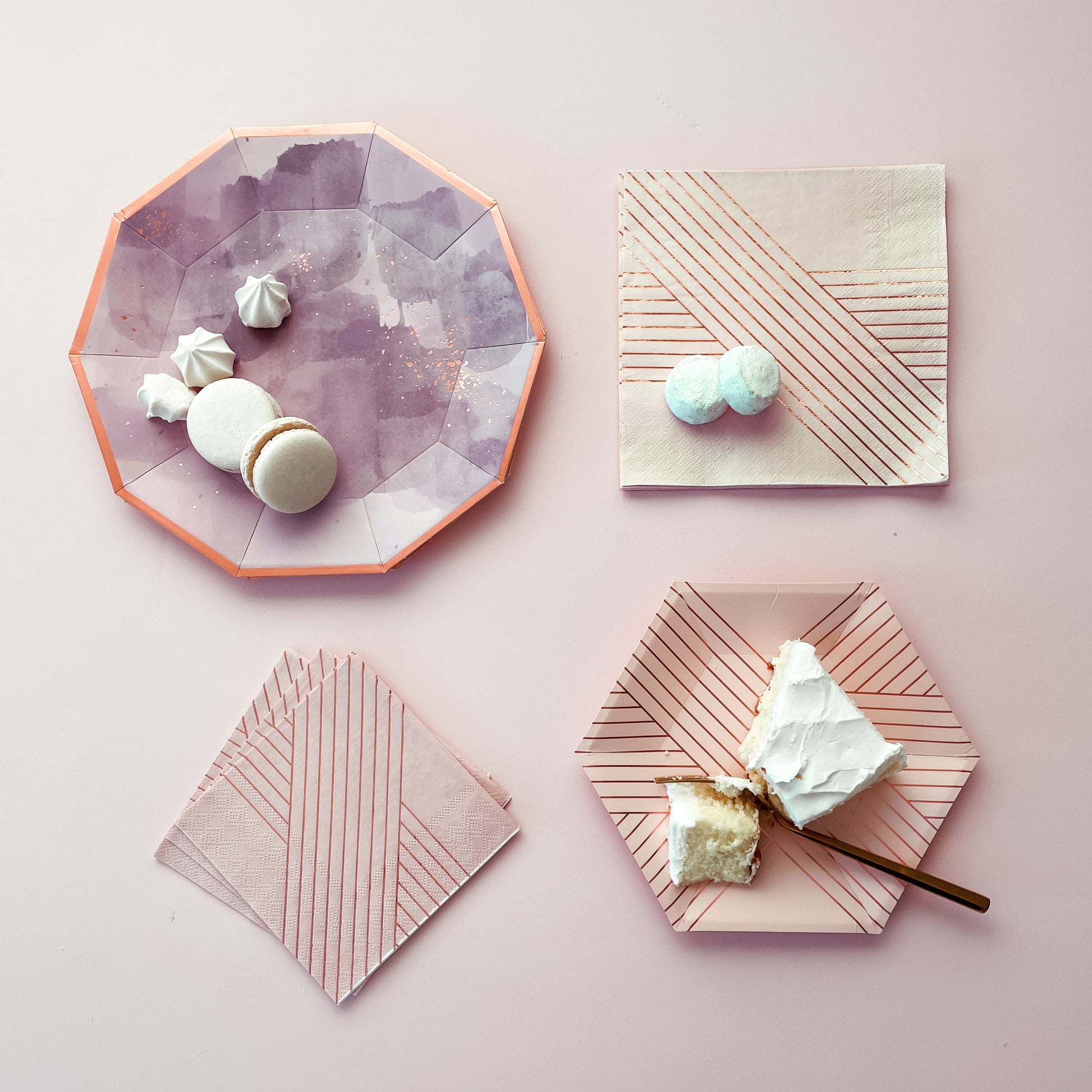 Amethyst light purple watercolor plate with rose-gold accents, paired with striped pink napkins in a pastel setting.