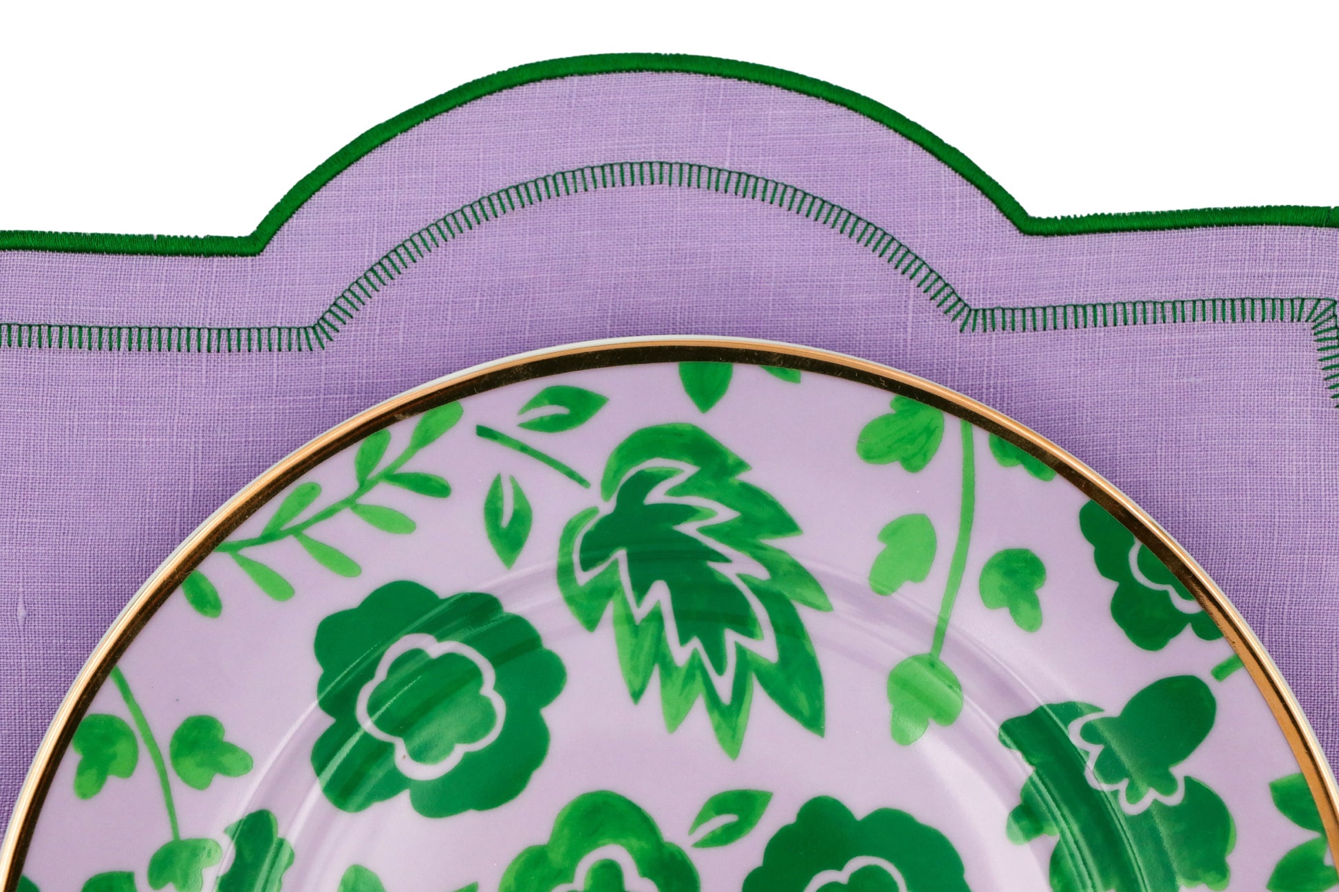 Bernadette Leaf Dinner Plate with green botanical pattern and gold rim; set of 4 plus 1 bonus on purple placemat.