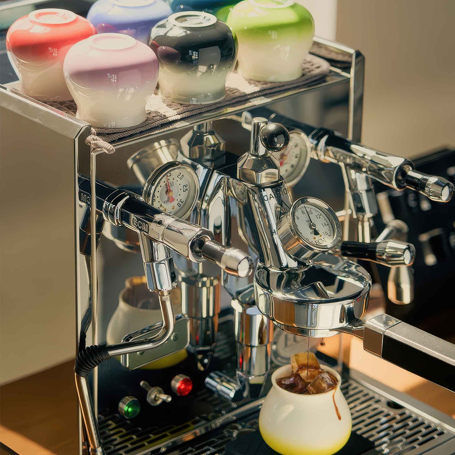 Ceramic Gradient Coffee Cups atop a chrome espresso machine, ready for brewing.