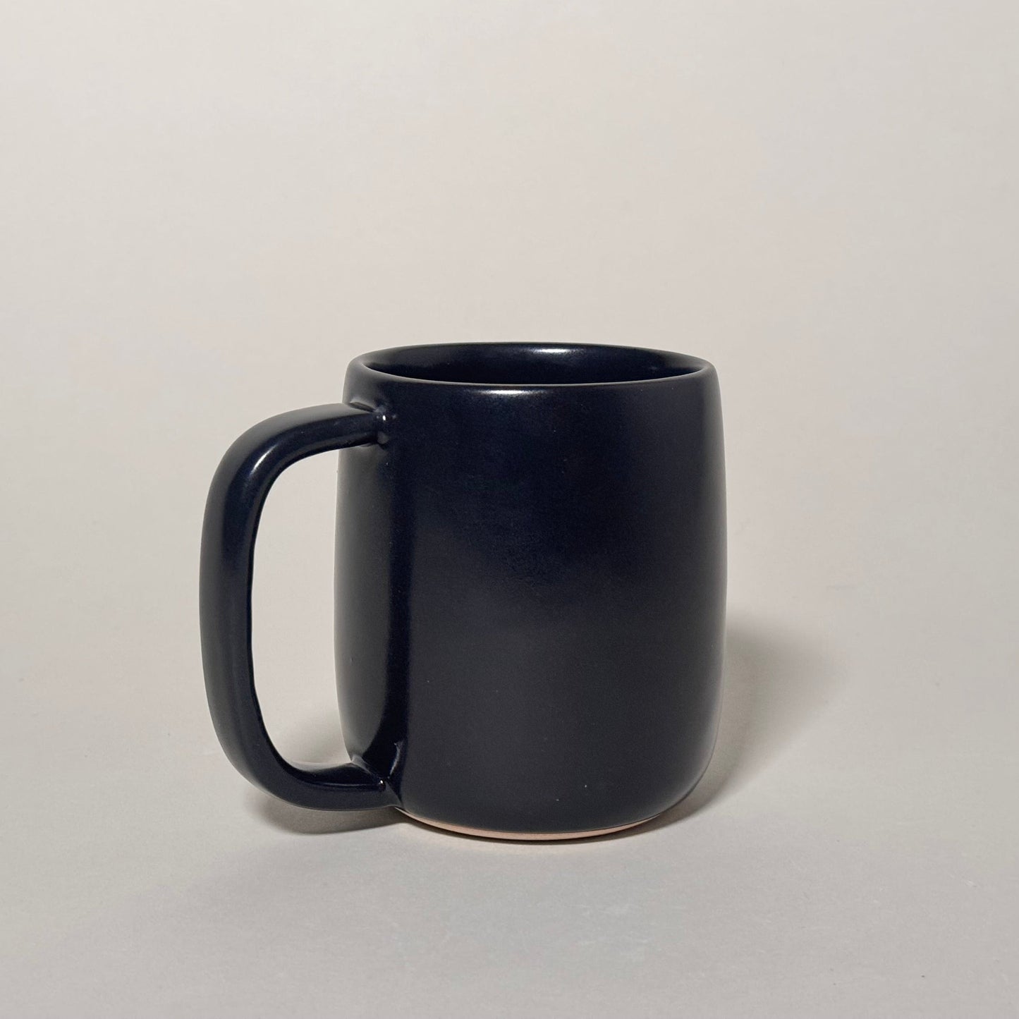 The Standard Mug in dark glaze, 12 oz capacity with a comfortable handle.