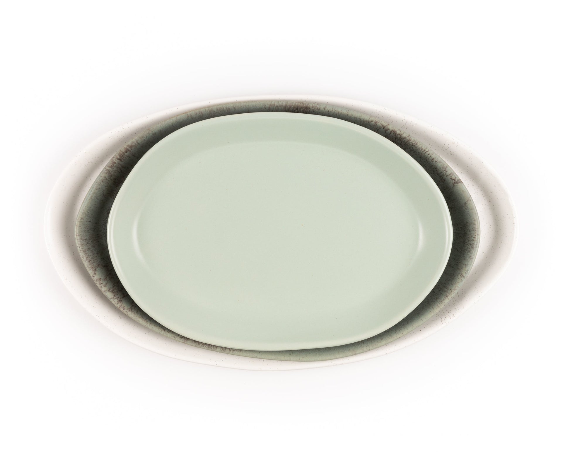 Three oval ceramic serving platters in white speckle, charcoal gray, and mint green, 13, 15, 18 inches.