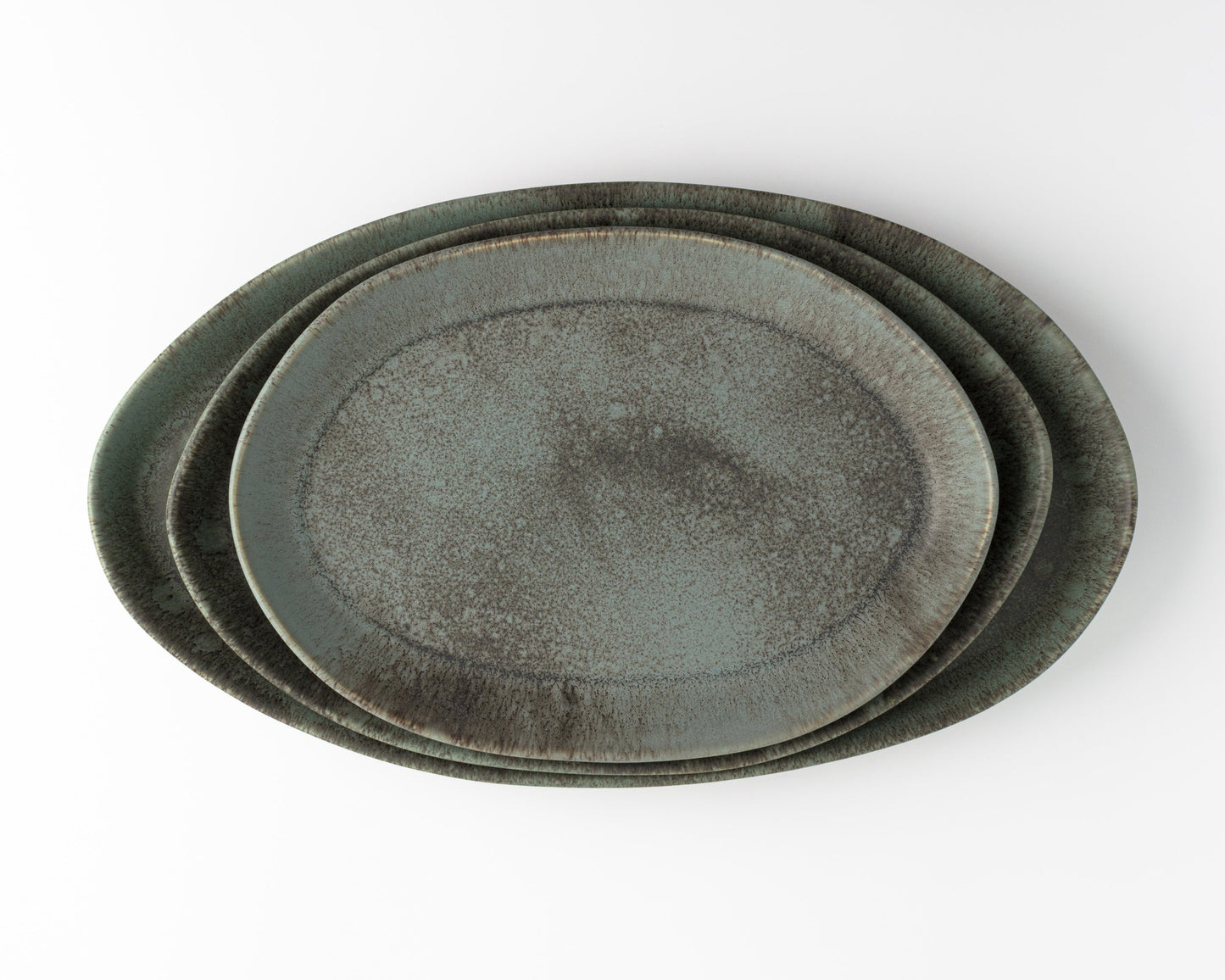 Three oval ceramic serving platters in green-gray speckled glaze (13, 15, 18 in)