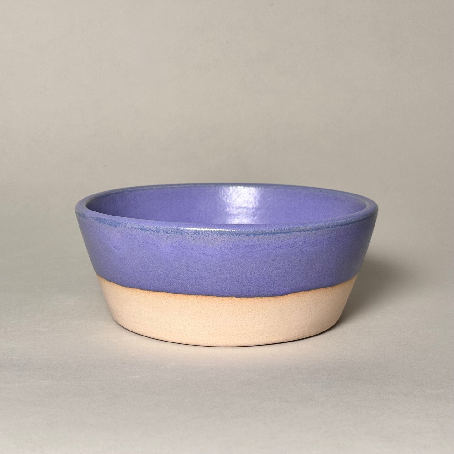 6-inch ceramic soup bowl with purple glaze on top and natural beige base.