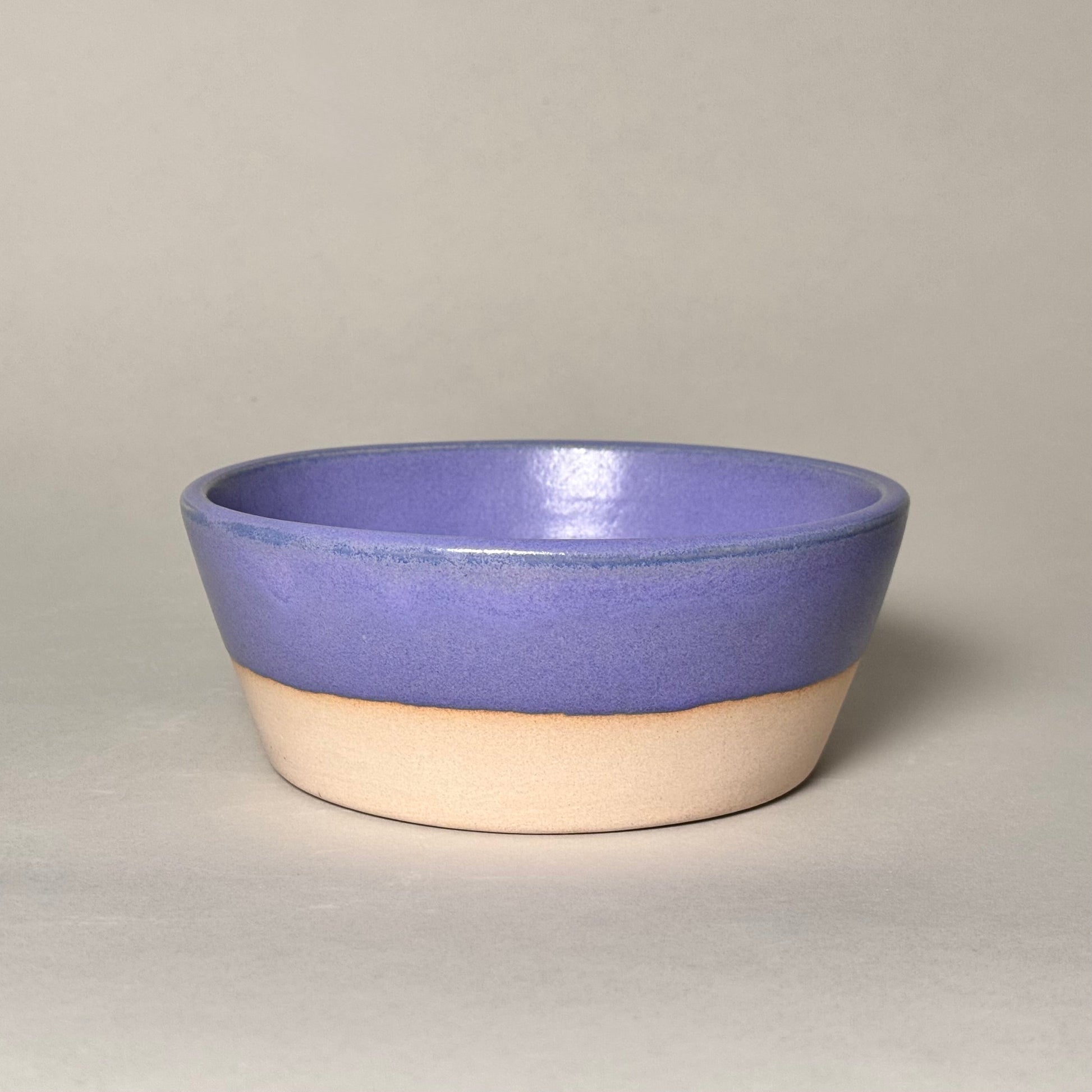 6-inch ceramic soup bowl with purple glaze on top and natural beige base.