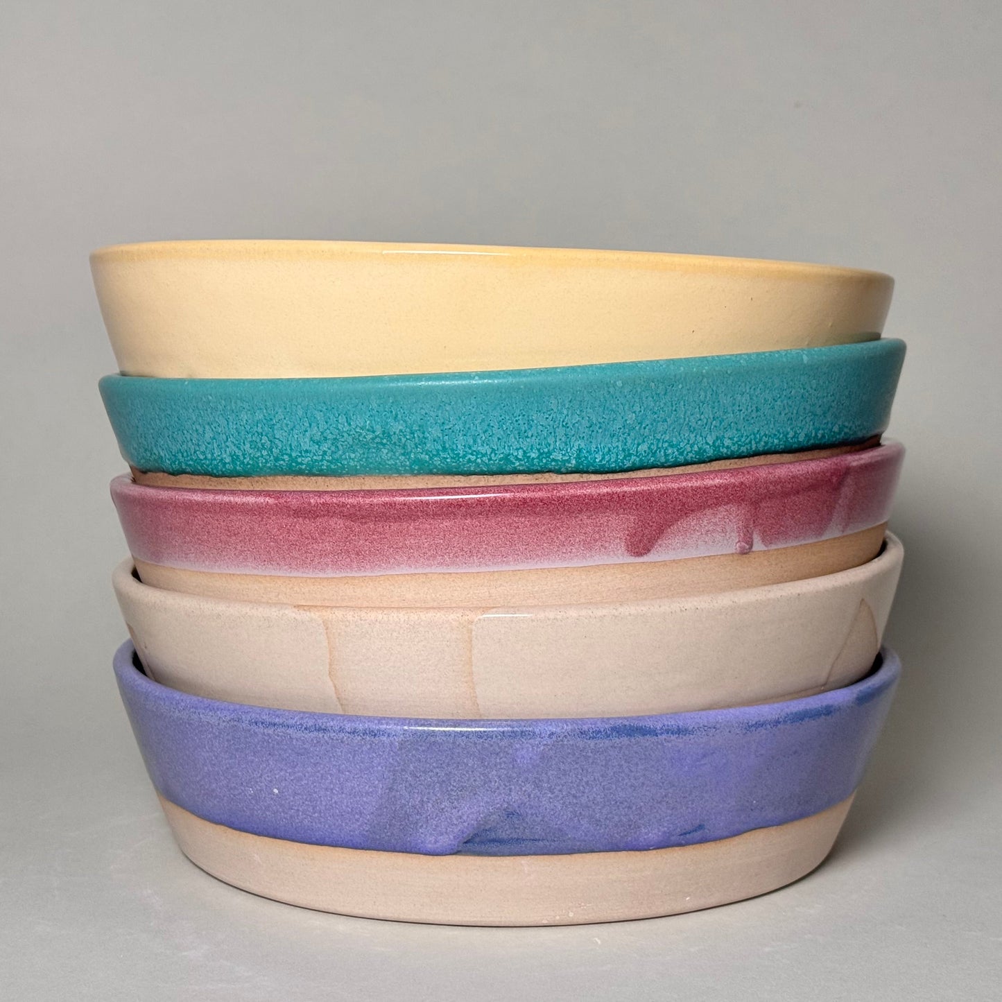 Share Bowl - 9 inch stack of five colorful bowls in yellow, teal, pink, beige, and lavender.