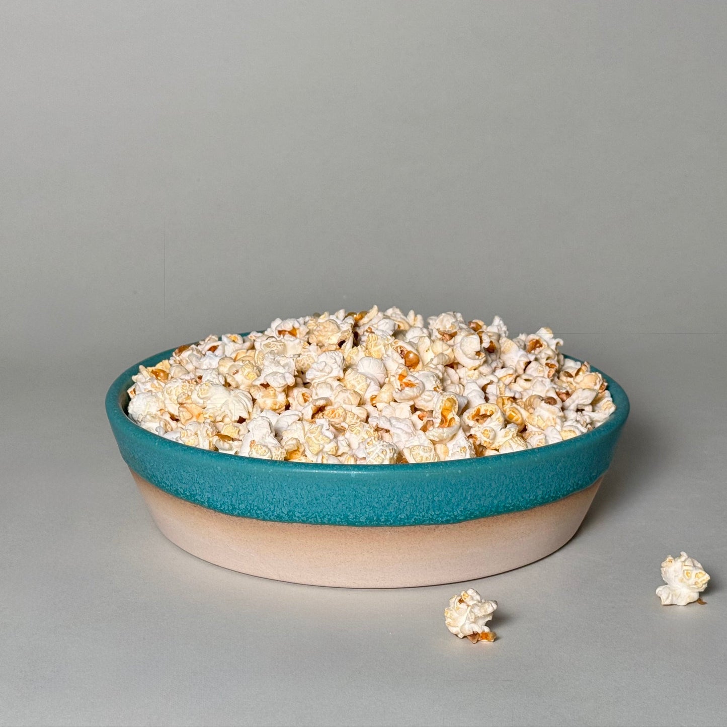 Share Bowl 9-inch teal and beige ceramic bowl filled with popcorn for family-style serving