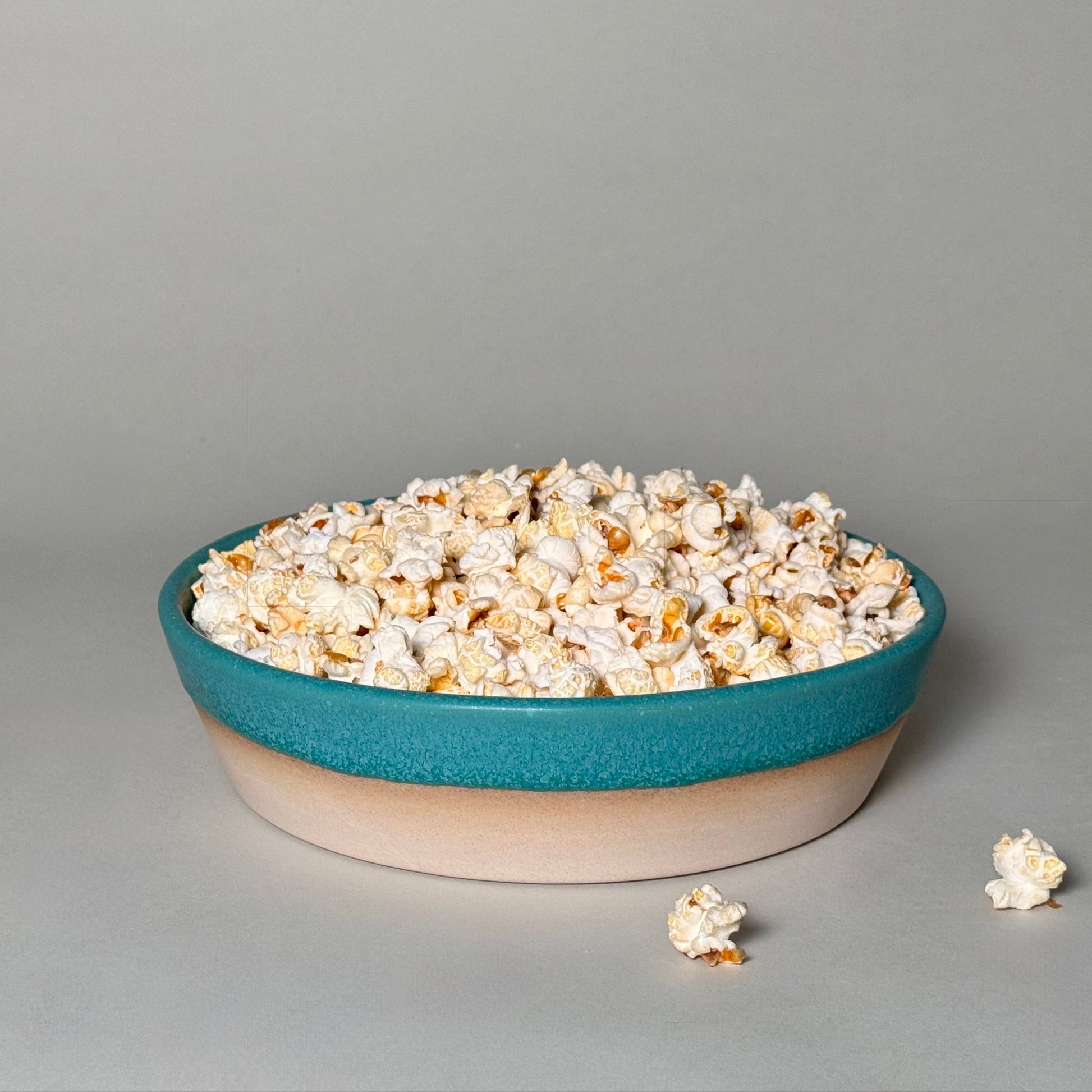 Share Bowl 9-inch teal and beige ceramic bowl filled with popcorn for family-style serving