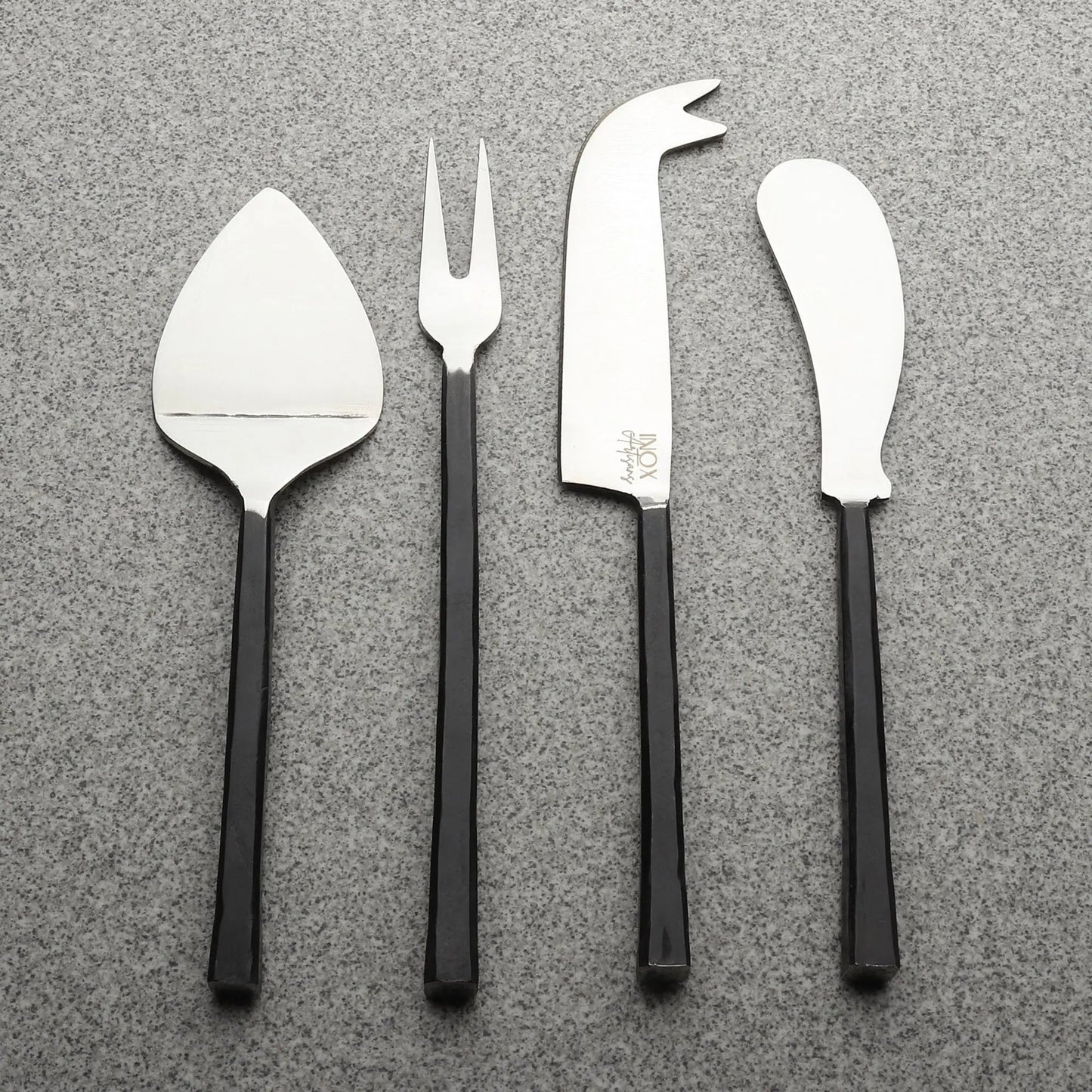 Jason Cheese Accessories 4 Pc. Set: four stainless steel cheese tools with black handles—spatula, fork, curved knife, and cheese knife.