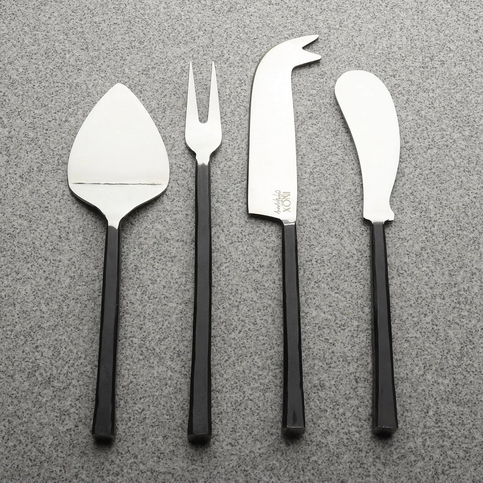 Jason Cheese Accessories 4 Pc. Set: four stainless steel cheese tools with black handles—spatula, fork, curved knife, and cheese knife.