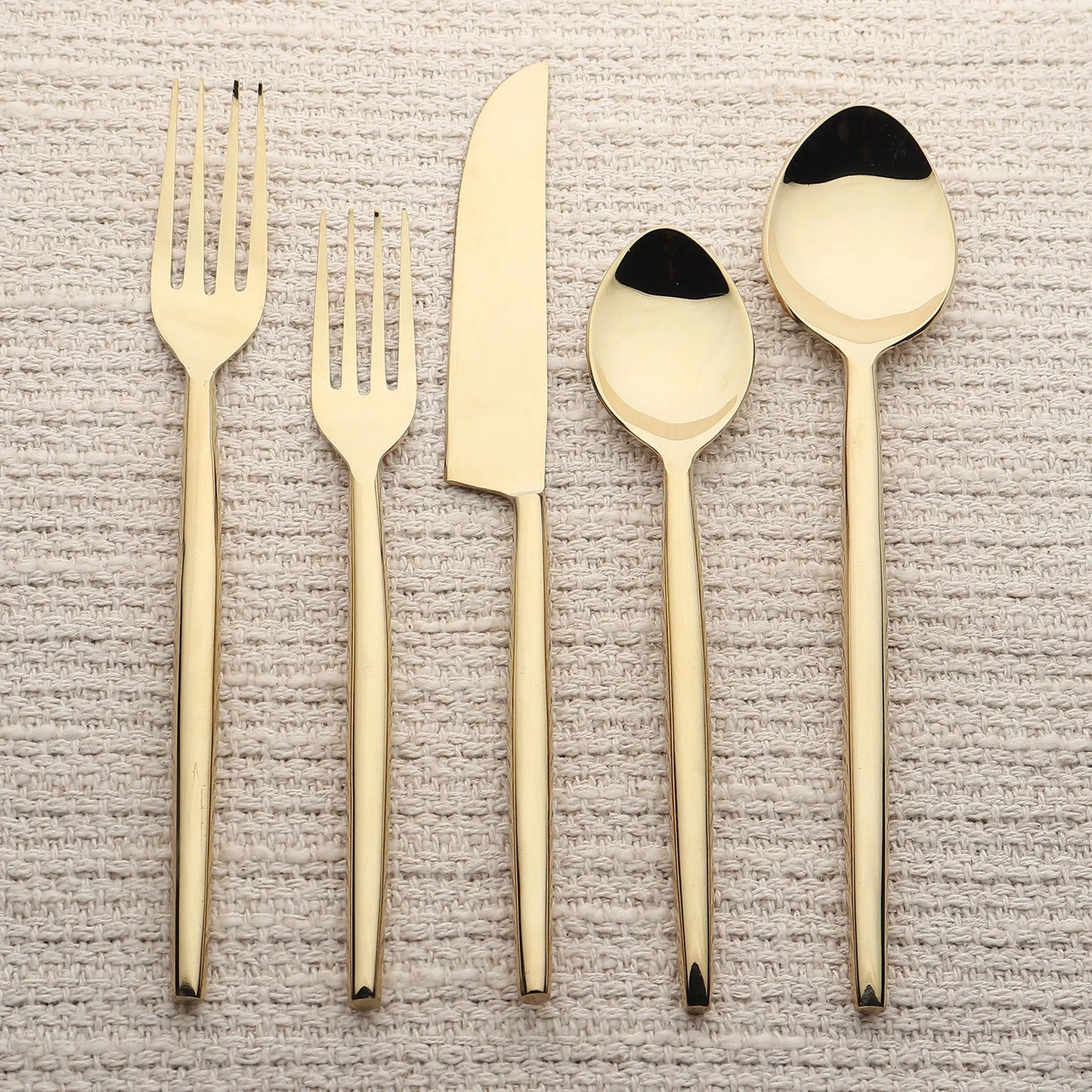 Brio PVD 5 Pc flatware set in gold-tone with slim tapered handles; includes forks, knife, tablespoon, and teaspoon.