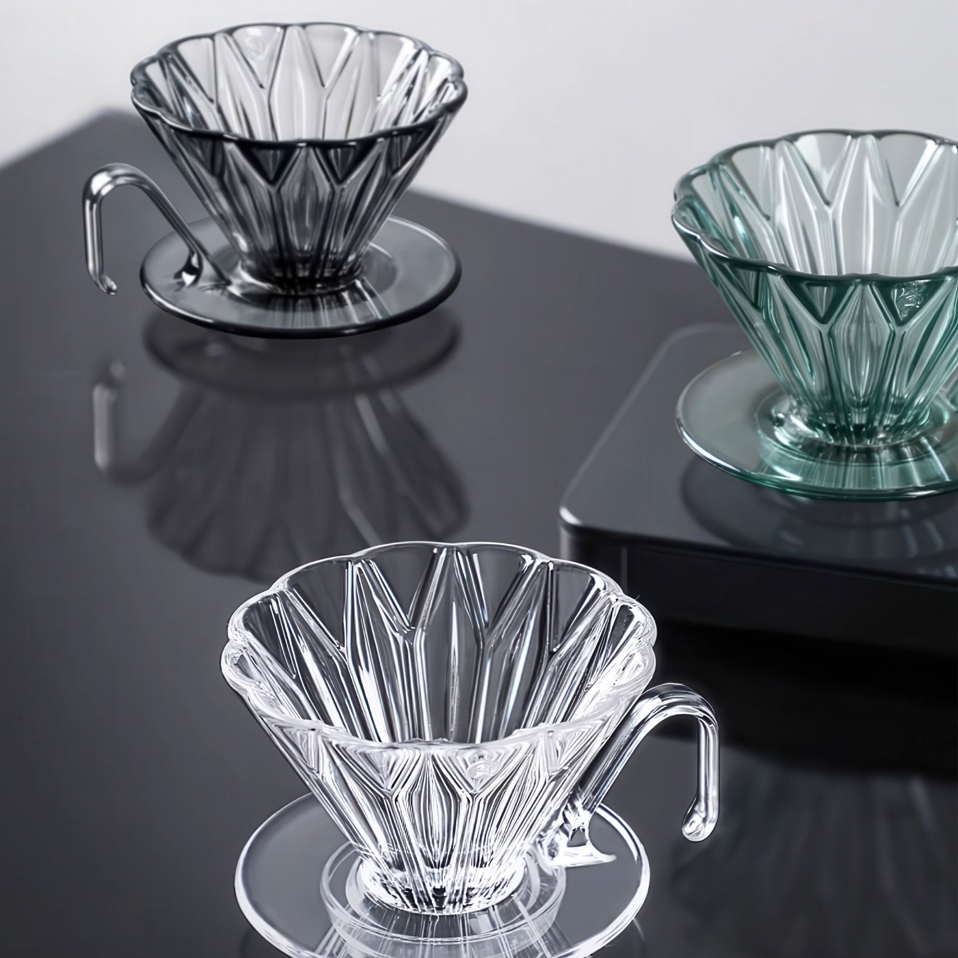 Diamond Pattern Prisma Pour Over Coffee Dripper in clear, smoky gray, and green PCTG with diamond ridges.