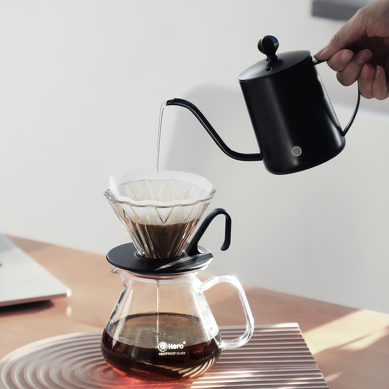 Gooseneck Pour Over Coffee Kettle pouring into a paper-filtered dripper over a glass carafe.