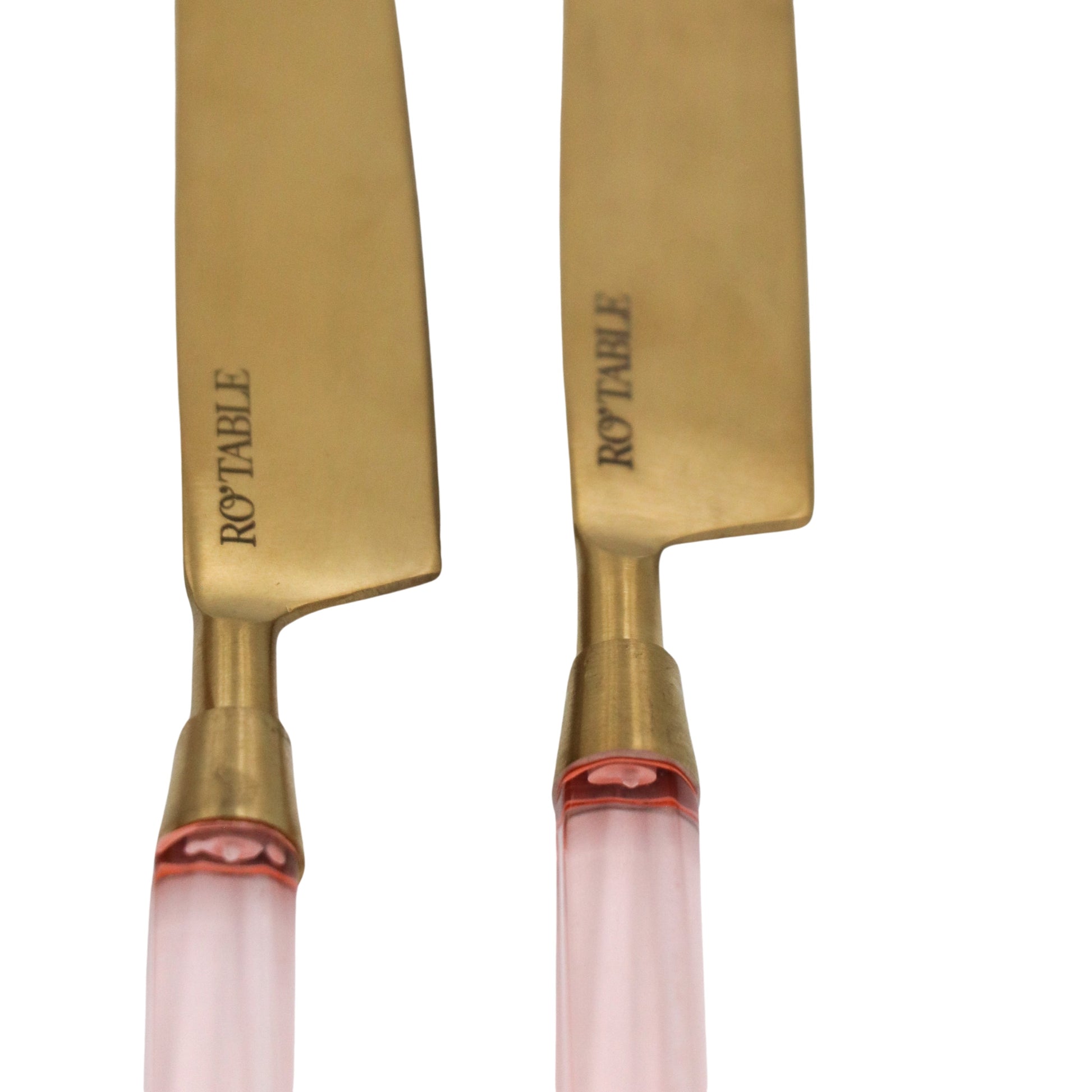 Gold-toned cutlery blades with blush pink translucent handles and RO'TABLE engraving.