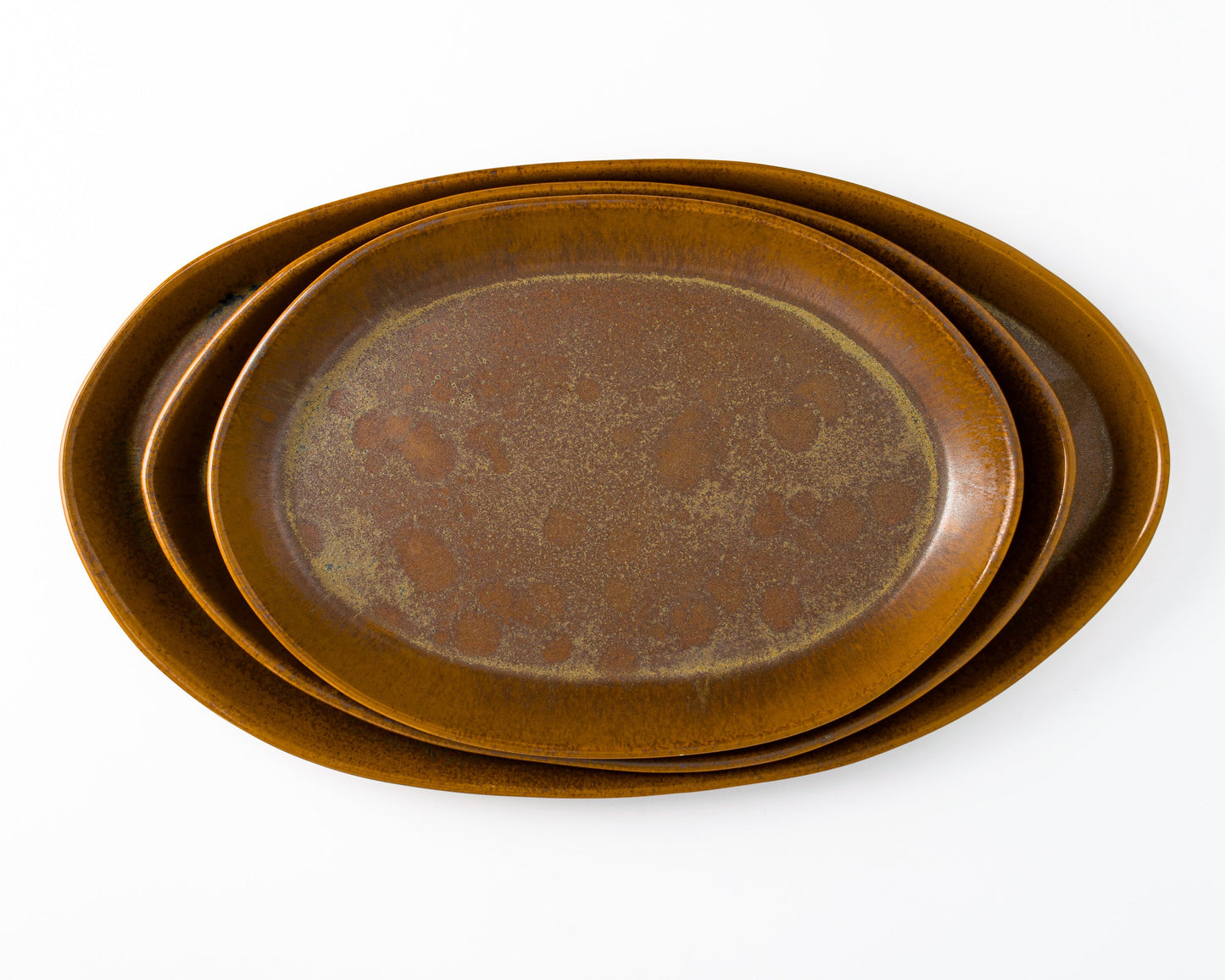 Three oval brown ceramic serving platters in 13, 15, and 18 inches, stacked.
