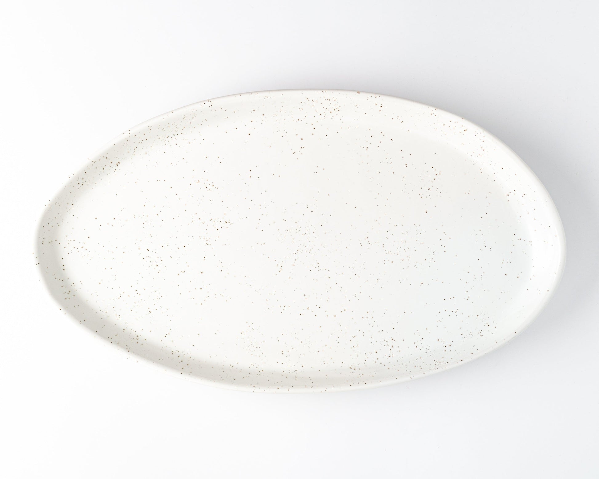 White speckled oval ceramic serving platter for entertaining.