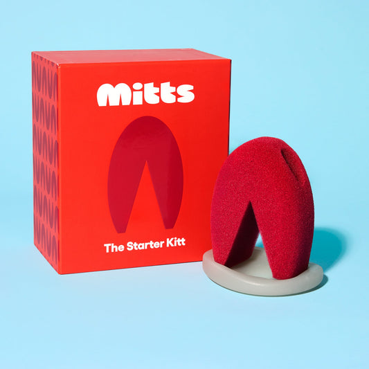 The Starter Kitt ergonomic red sponge with non-abrasive design and gray ring-dish base beside red packaging.