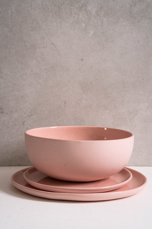 Powder pink handmade porcelain salad serving bowl with matching plates.