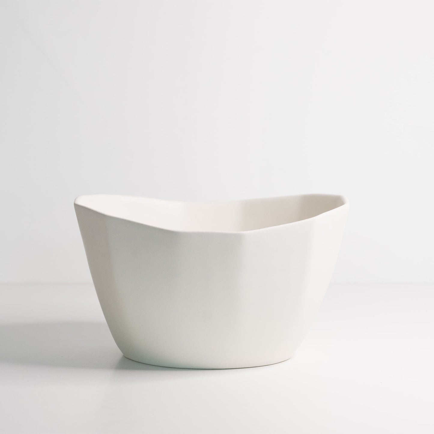 Medium porcelain nesting bowl with organic, wavy rim; handmade, versatile for snacks, ice cream, or soup.