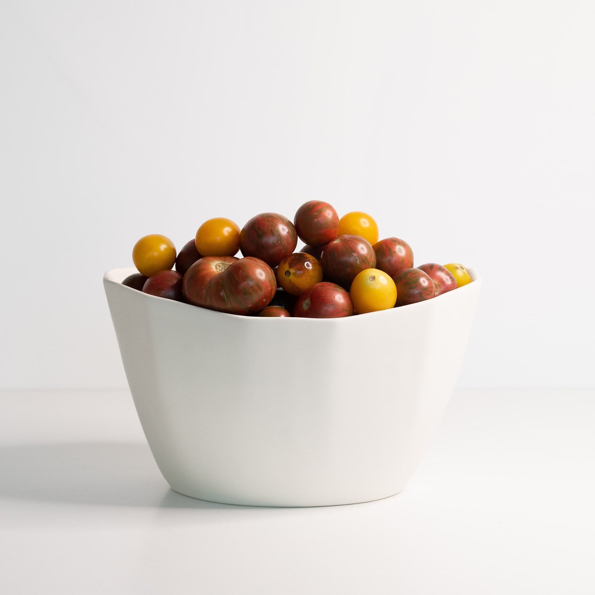 Medium Porcelain Nesting Bowl filled with red and yellow cherry tomatoes