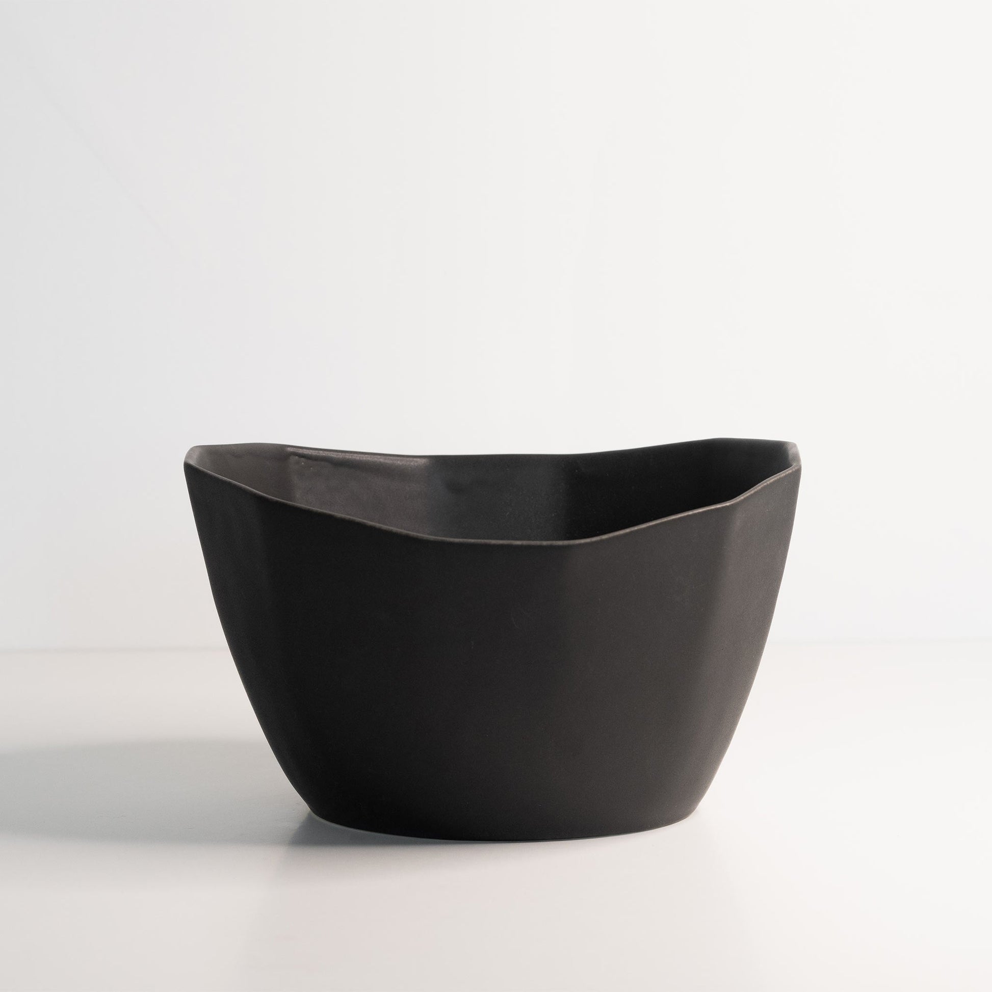 Medium Porcelain Nesting Bowl in black matte ceramic, handmade and versatile for snacks, ice cream, or soup.