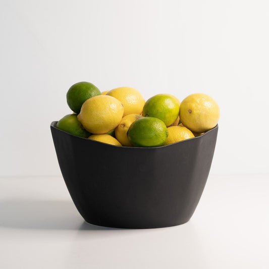 Medium Porcelain Nesting Bowl filled with lemons and limes.