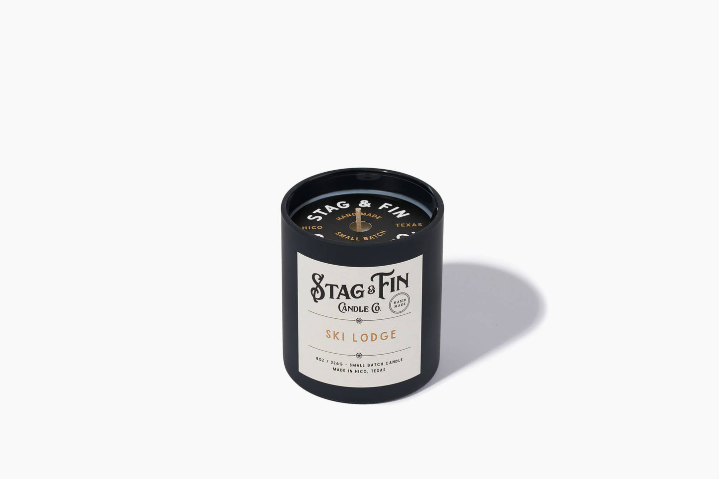 Ski Lodge 8oz candle in a navy tin with cream label from Stag & Fin Candle Co.