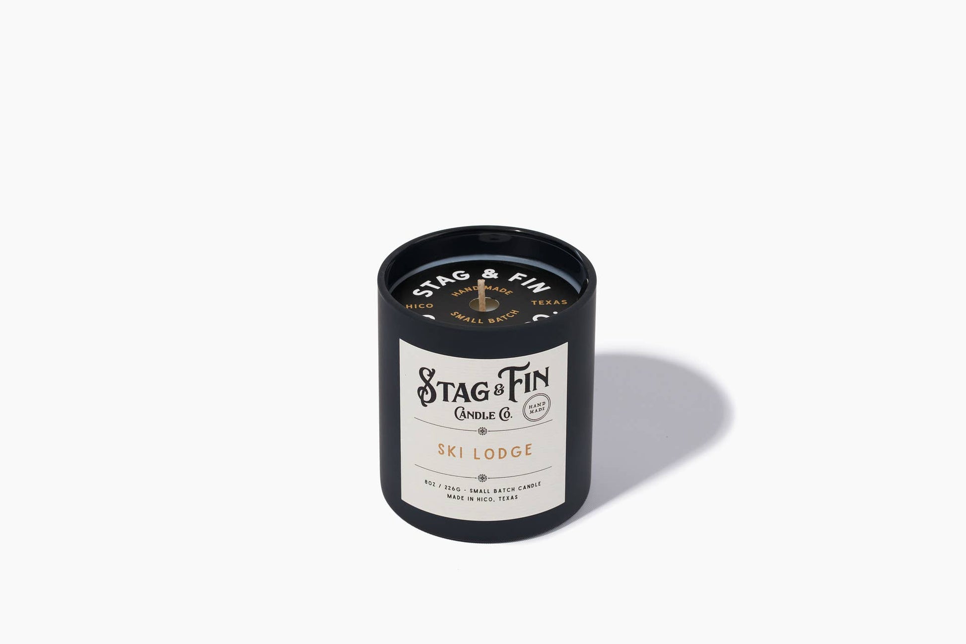 Ski Lodge 8oz candle in a navy tin with cream label from Stag & Fin Candle Co.