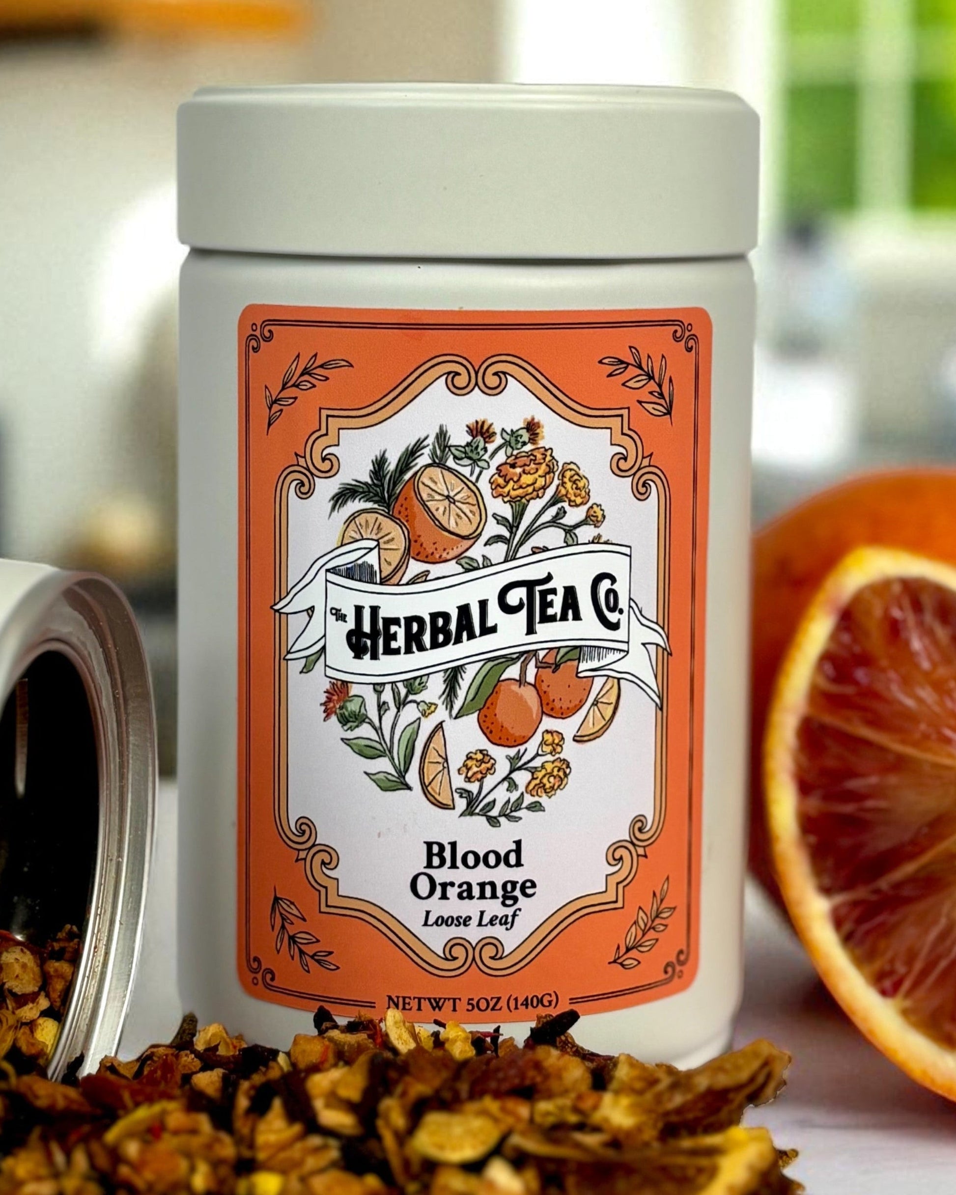 Blood Orange Herbal Tea loose-leaf in an orange-labeled jar with citrus botanical artwork.