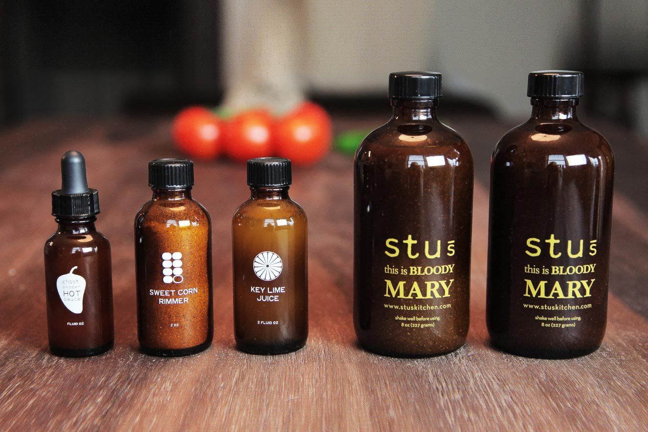 Stu's Bloody Mary Mixology Kit with labeled sauces and two Stu's Mary bottles for a full Bloody Mary bar.