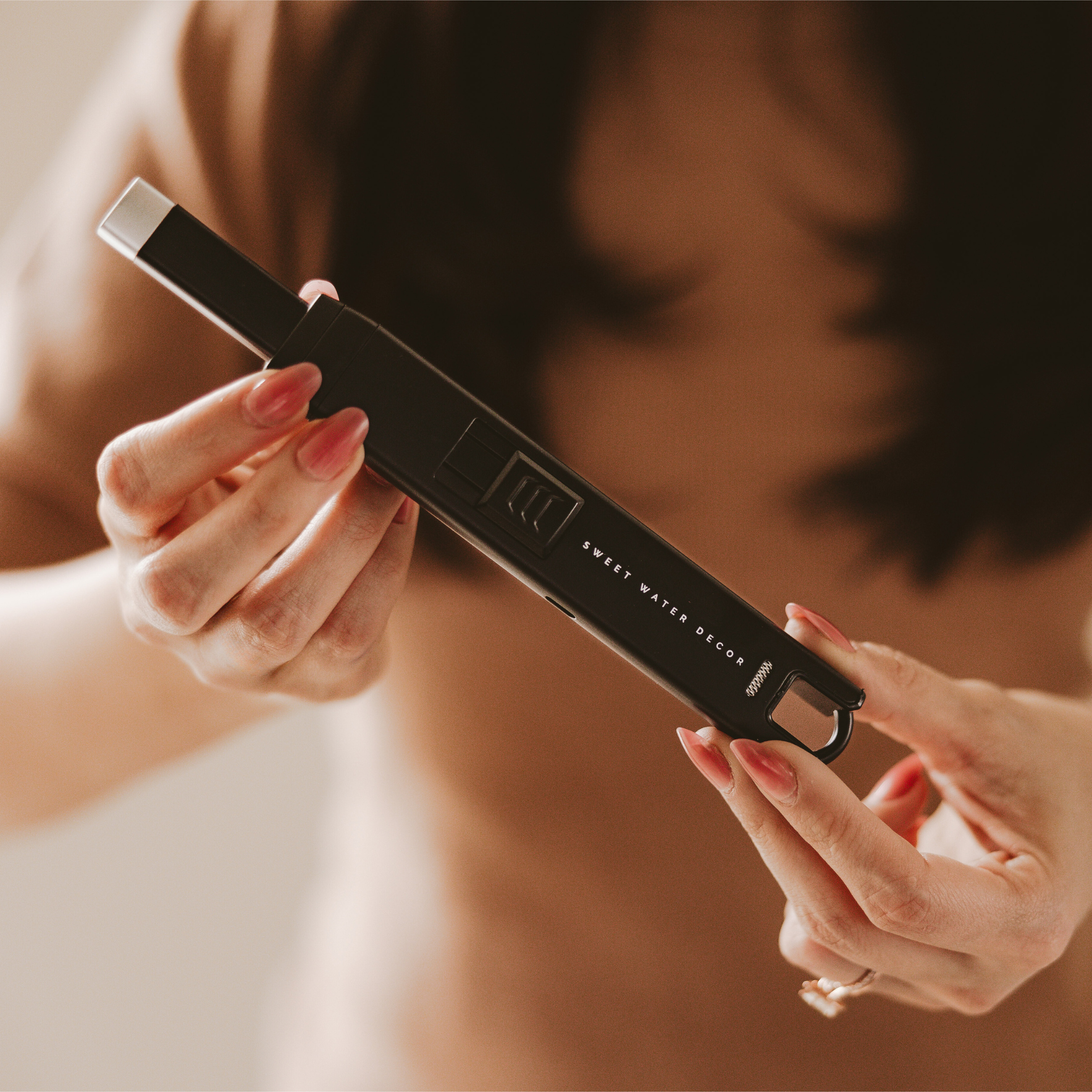 Person holding a Black Large Rechargeable Electric Lighter with an oversized grip and modern design.