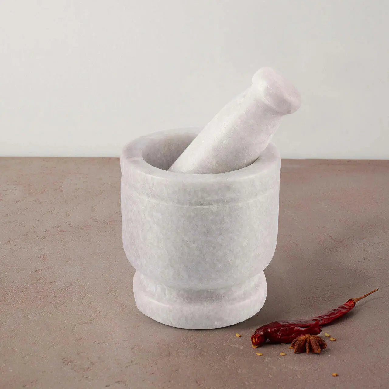 Cassia Marble Mortar and Pestle in white marble; perfect for grinding herbs and spices; unique variations.