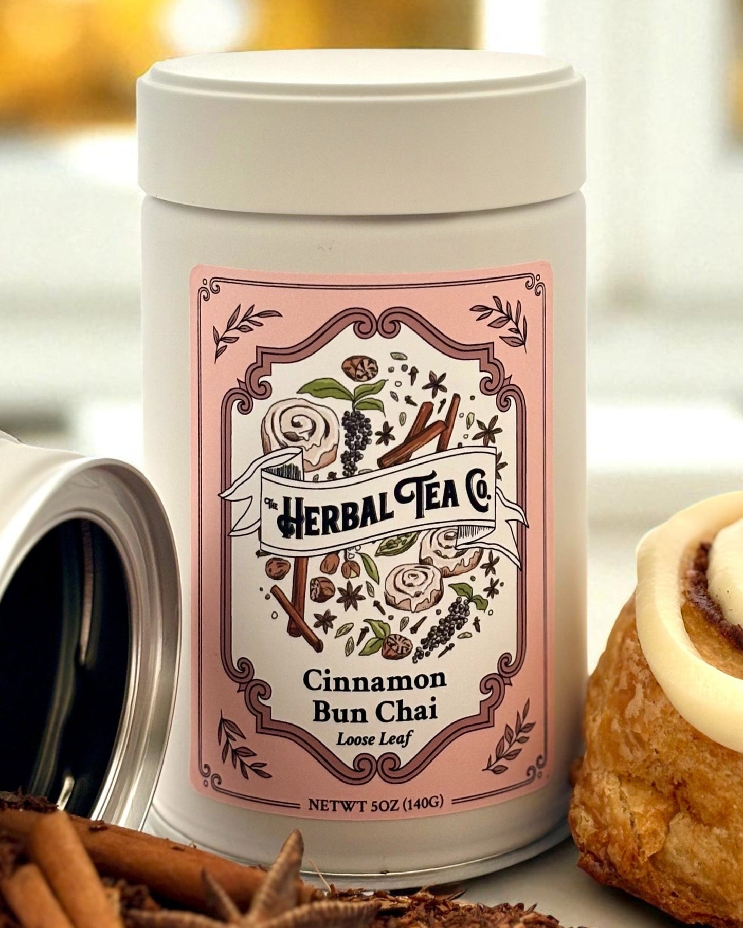 Cinnamon Bun Chai Herbal Tea rooibos-based loose leaf in pink label tin with cinnamon bun and spices.