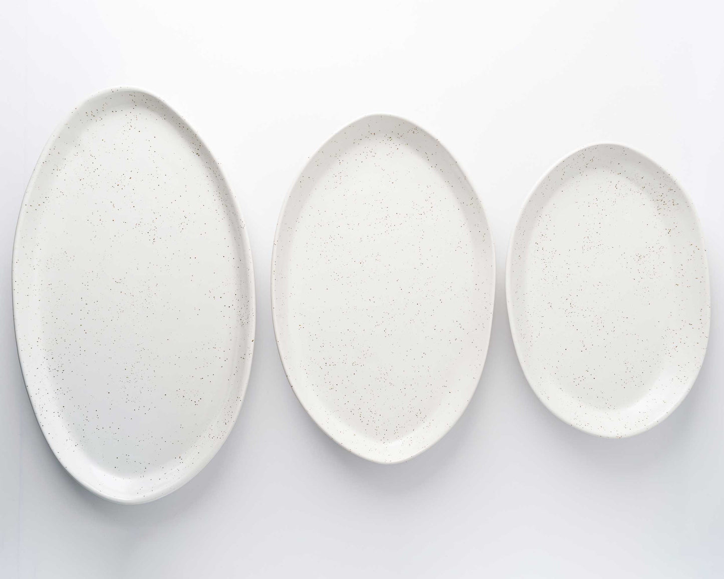 3 Piece Serving Platter Set: speckled white oval platters in 13, 15, and 18 inches.