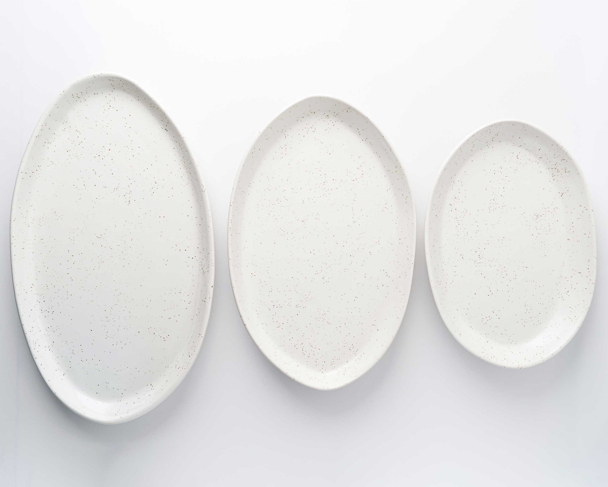 3 Piece Serving Platter Set: speckled white oval platters in 13, 15, and 18 inches.