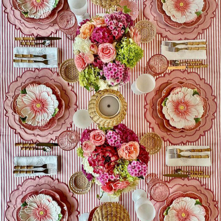 Harmony Pink Round Fabric Placemat, cotton blend, on a floral striped table setting.