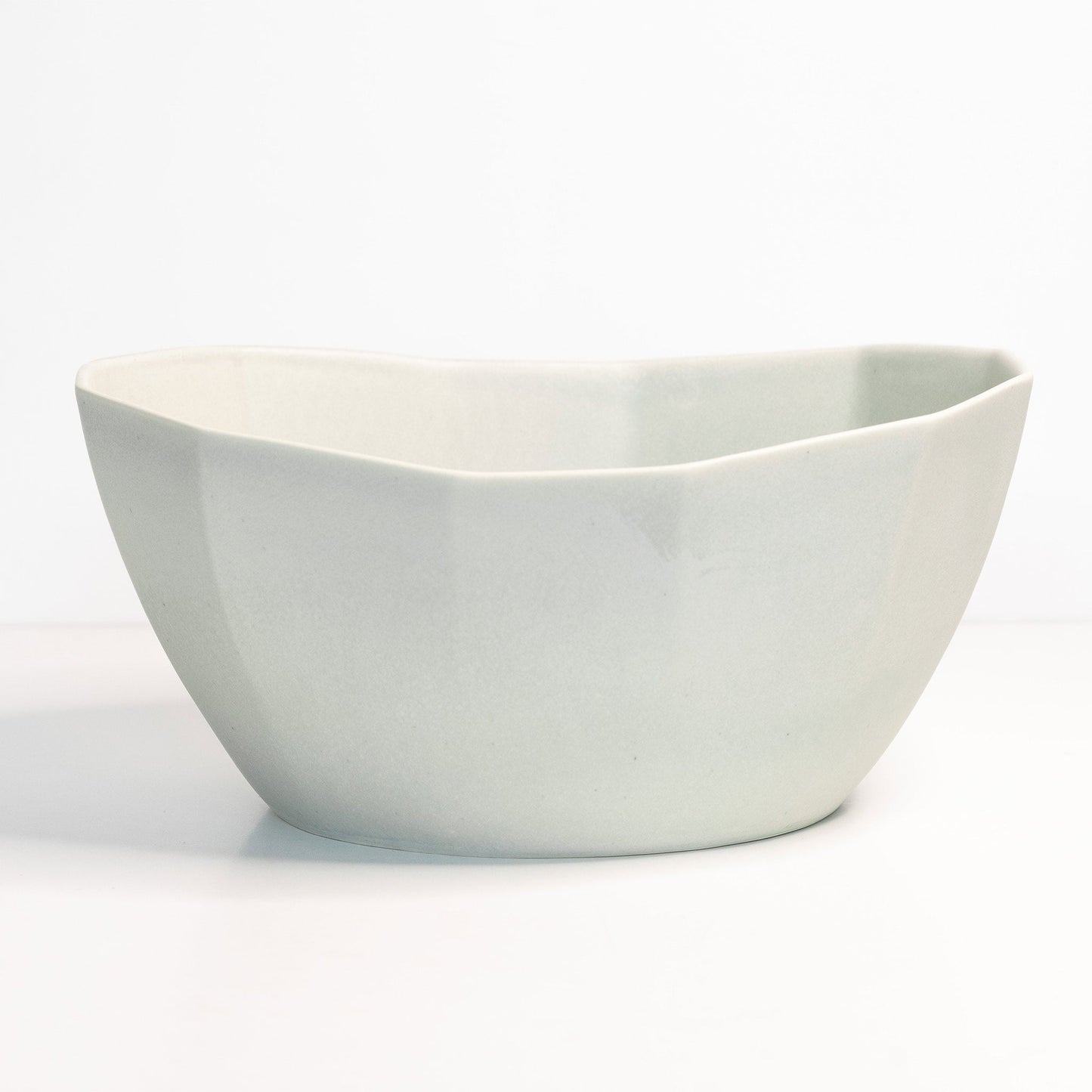 Ember Collective Large Porcelain Nesting Bowl, handmade white porcelain with a curved rim, ideal for pasta or salads.
