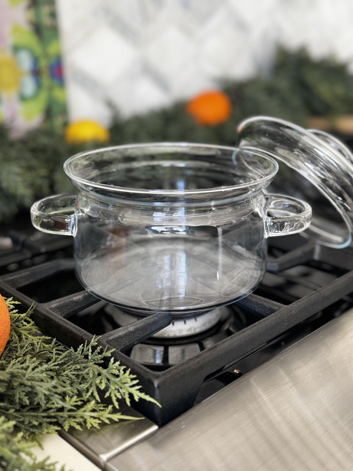 1.5 Liter Clear Glass Simmer Pot with Matching Lid on a stovetop.