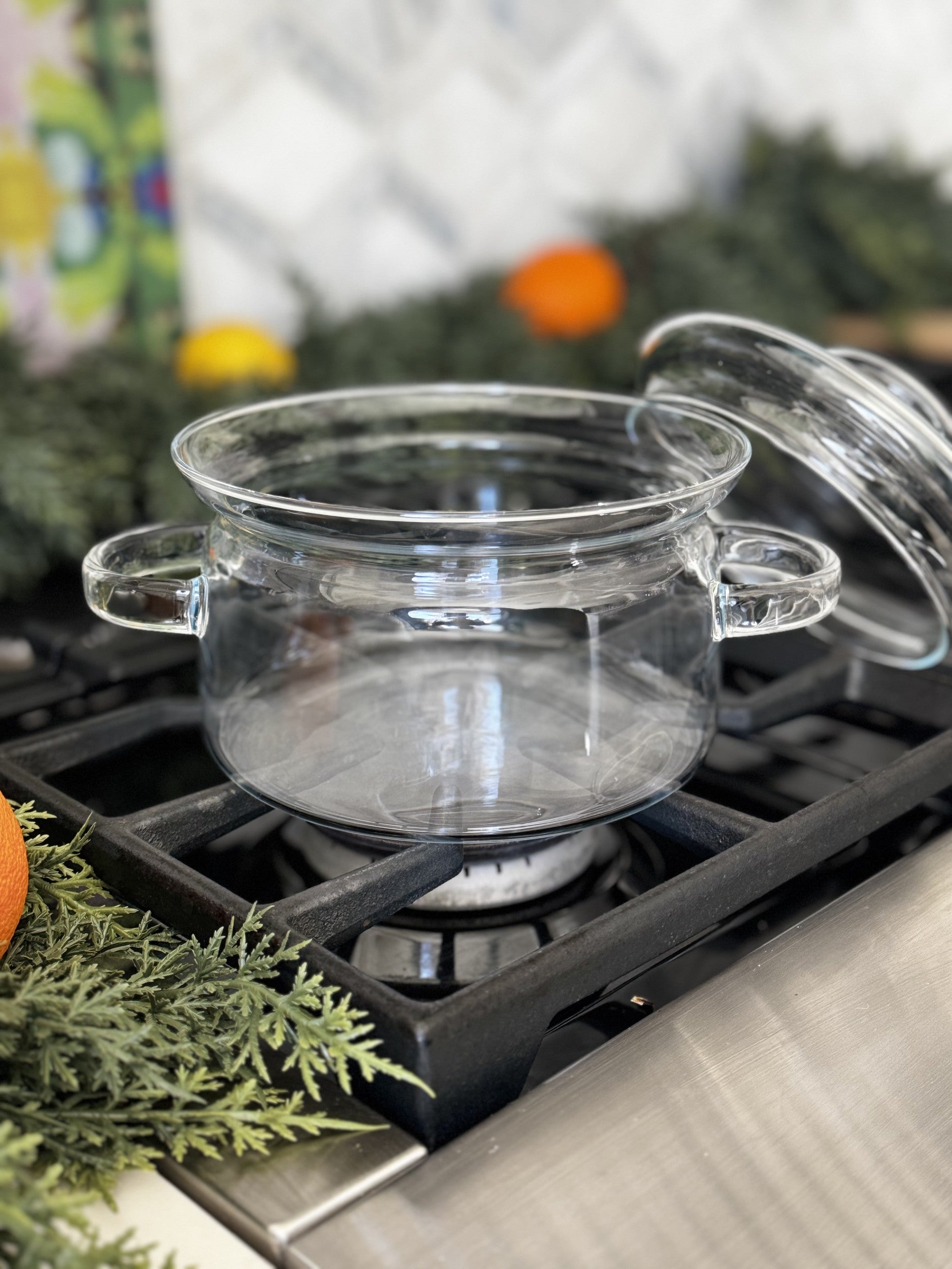 1.5 Liter Clear Glass Simmer Pot with Matching Lid on a stovetop.